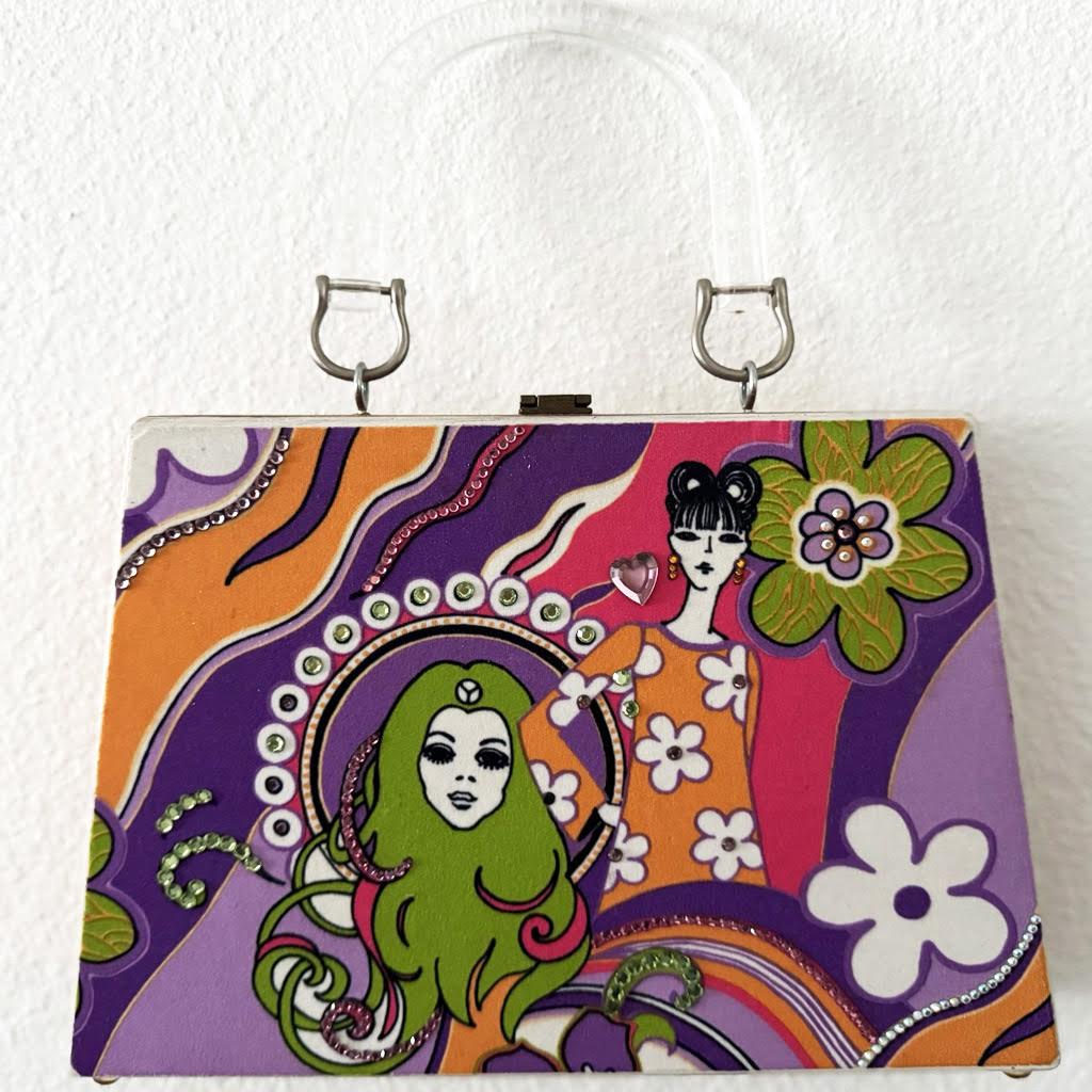 Wooden pyramid-shaped handbag with bright colors and a women's face.